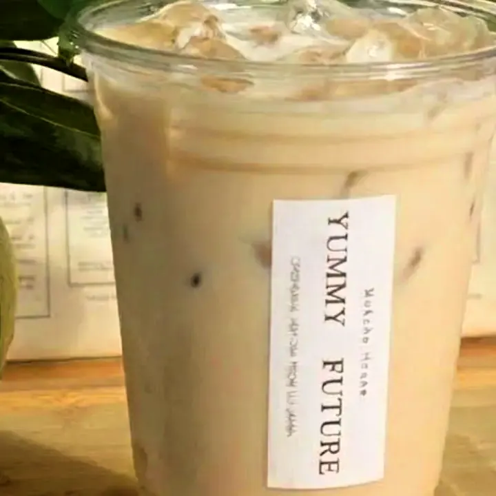 An iced tea latte with the vertical paper label: Matcha House, YUMMY FUTURE